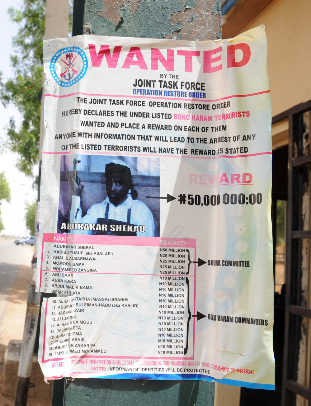 A poster in the northeastern city of Maiduguri shows a photograph of Abubakar Shekau, a Boko Haram leader who has claimed responsibility for recent attacks. The U.S. has placed a $7 million bounty on Shekau.
