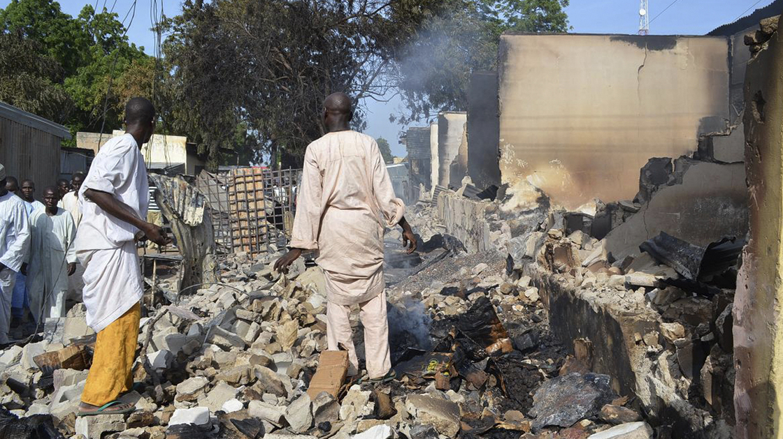 Men walk amid rubble after Boko Haram militants raided the town of Benisheik in northeast Nigeria, on Sept. 19. The Islamist group has been waging an insurgency in northern and central Nigeria for the last four years and was recently placed on the U.S. list of terrorist groups.