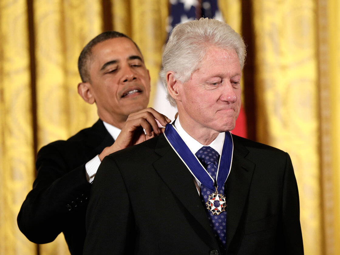 From one president to another: Former President Bill Clinton receives the Presidential Medal of Freedom from current President Obama.