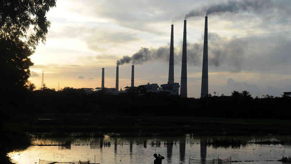 The chimneys of the Kolaghat Thermal Power Station loom above a field flooded for rice farming near Mecheda, West Bengal, India, in July 2011. The chimneys of the Kolaghat Thermal Power Station loom above a field flooded for rice farming near Mecheda, West Bengal, India, in July 2011.