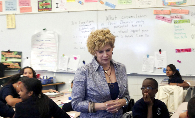 Julia de Burgos Elementary teacher Gail Kantor, shown here in her sixth-grade class, says she buys things like clothing, books and school supplies for her students with her own money. 'Some kids don't ever have a dime,' she says. (Image credit: NPR)