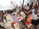 Municipal guards with batons chase a mob of thieves that snatched bags and wallets from beachgoers on Arpoador beach, adjacent to Ipanema, in Rio de Janeiro on Nov. 20. Municipal guards with batons chase a mob of thieves that snatched bags and wallets from beachgoers on Arpoador beach, adjacent to Ipanema, in Rio de Janeiro on Nov. 20.