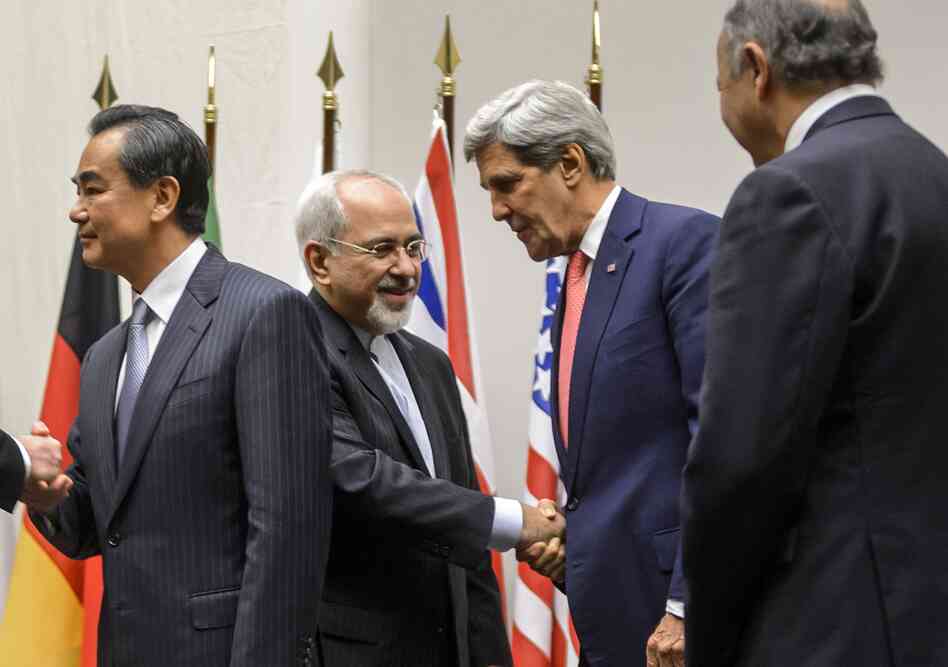 Iranian Foreign Minister Mohammad Javad Zarif (second from left) shakes hands with U.S. Secretary of State John Kerry next to Chinese Foreign Minister Wang Yi (far left) and French Foreign Minister Laurent Fabius (far right) after a statement on early November 24, 2013 in Geneva. Iranian Foreign Minister Mohammad Javad Zarif (second from left) shakes hands with U.S. Secretary of State John Kerry next to Chinese Foreign Minister Wang Yi (far left) and French Foreign Minister Laurent Fabius (far right) after a statement on early November 24, 2013 in Geneva.