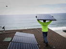 Andres Quiroz, an installer for Stellar Solar, carries a solar panel during installation at a home in Encinitas, Calif. Andres Quiroz, an installer for Stellar Solar, carries a solar panel during installation at a home in Encinitas, Calif.