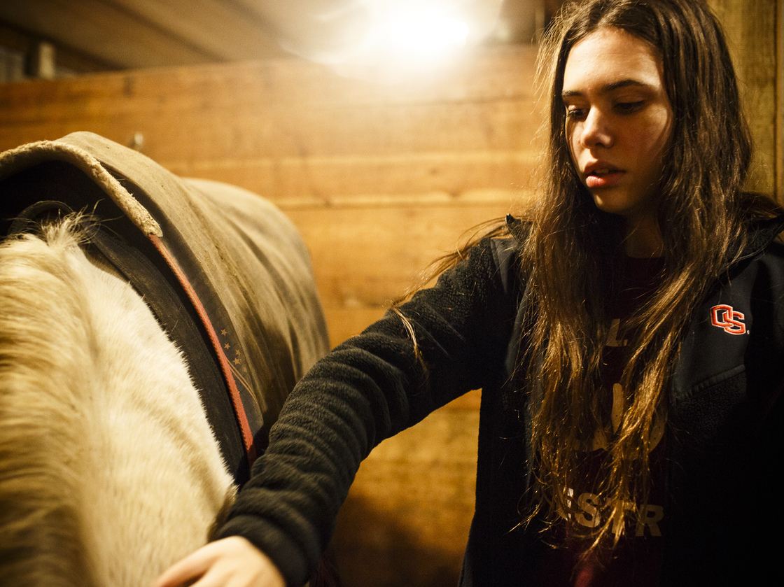 Colleen pets her horse, Bishop. They had been missing out on rides together because of homework.