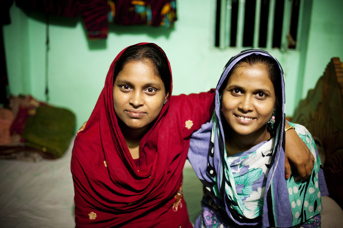 Minu (left) and her younger sister Shumi worked on the Planet Money men's T-shirt.