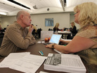 Health care specialist Stacy Chagolla helps William Bishop compare plans at an Affordable Care Act enrollment fair in Pasadena, Calif., this month. Health care specialist Stacy Chagolla helps William Bishop compare plans at an Affordable Care Act enrollment fair in Pasadena, Calif., this month.