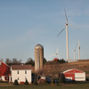 Wind turbines twirl above farmland on the outskirts of Madison, Wis. Not all locals are pleased.