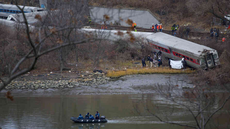 Search and rescue teams work at the scene of Sunday's passenger train crash in the Bronx. The train crash killed four people and injured dozens more. Search and rescue teams work at the scene of Sunday's passenger train crash in the Bronx. The train crash killed four people and injured dozens more.