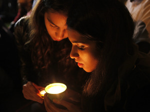 People light a candle for former president Nelson Mandela on hearing of his death outside his home in Johannesburg, South Africa on Thursday.