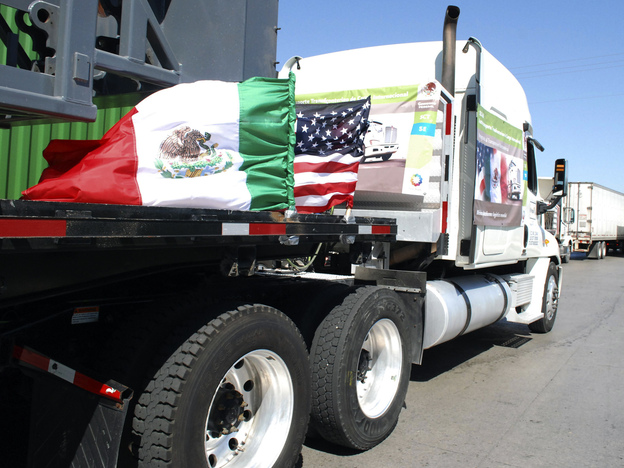A truck bearing Mexican and U.S. flags approaches the border crossing into the U.S., in Laredo, Texas. (Image credit: Reuters /Landov)
