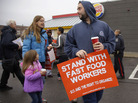 Protesters in Boston march in the parking lot of a Burger King as part of a nation-wide protest supporting higher wages for workers in the fast-food industry. Protesters in Boston march in the parking lot of a Burger King as part of a nation-wide protest supporting higher wages for workers in the fast-food industry.