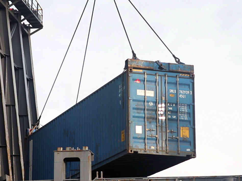 The container carrying the Planet Money women's T-shirts is loaded onto a ship in Cartagena, Colombia. The container carrying the Planet Money women's T-shirts is loaded onto a ship in Cartagena, Colombia.