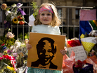 Karla Truter, aged 3, holds up a portrait of Mandela outside the City Hall. Karla Truter, aged 3, holds up a portrait of Mandela outside the City Hall.