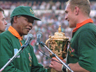 In 1995, South African rugby captain Francios Pienaar receives the Rugby World Cup from President Nelson Mandela, who wears the green Springbok jersey. In 1995, South African rugby captain Francios Pienaar receives the Rugby World Cup from President Nelson Mandela, who wears the green Springbok jersey.