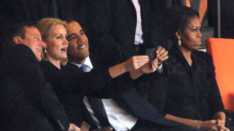 President Obama and British Prime Minister David Cameron pose for a picture with Denmark's Prime Minister, Helle Thorning Schmidt, during the memorial service for Nelson Mandela Tuesday in Johannesburg, South Africa. First lady Michelle Obama is on the right. President Obama and British Prime Minister David Cameron pose for a picture with Denmark's Prime Minister, Helle Thorning Schmidt, during the memorial service for Nelson Mandela Tuesday in Johannesburg, South Africa. First lady Michelle Obama is on the right.
