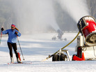 A skier glides past a snow-making machine pumping out snow in Weston, Mass., in 2010. A skier glides past a snow-making machine pumping out snow in Weston, Mass., in 2010.