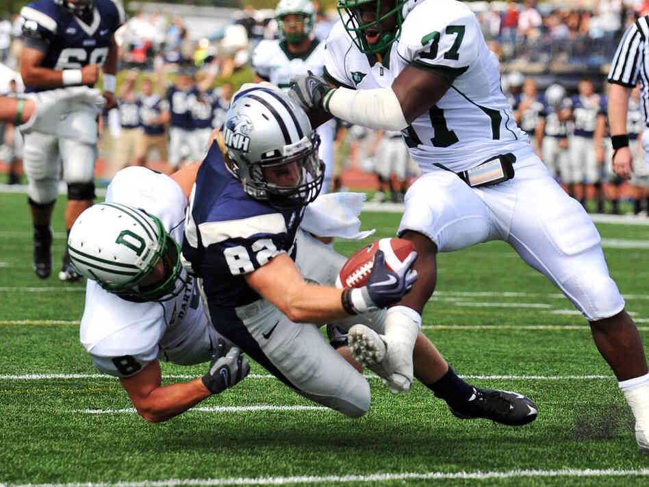 Dartmouth defenders sandwich a New Hampshire wide receiver during a game in Durham, N.H., in 2009. Dartmouth defenders sandwich a New Hampshire wide receiver during a game in Durham, N.H., in 2009.