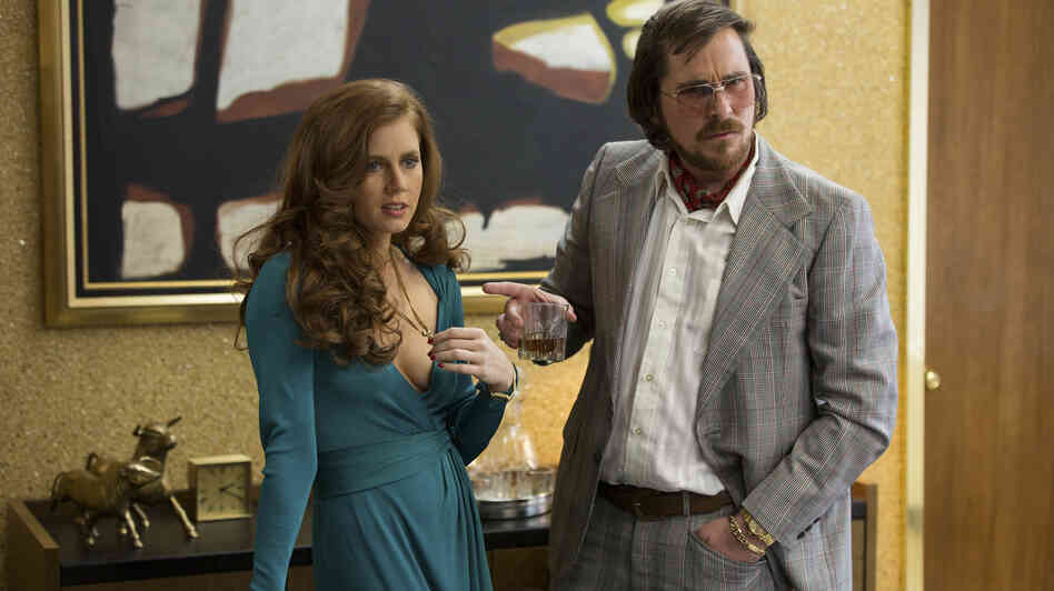 Amy Adams and Christian Bale star as a couple of con artists in David O. Russell's American Hustle. Amy Adams and Christian Bale star as a couple of con artists in David O. Russell's American Hustle.