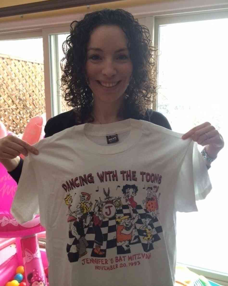 This is Jennifer, holding one of the extra shirts from her bat mitzvah. This is Jennifer, holding one of the extra shirts from her bat mitzvah.