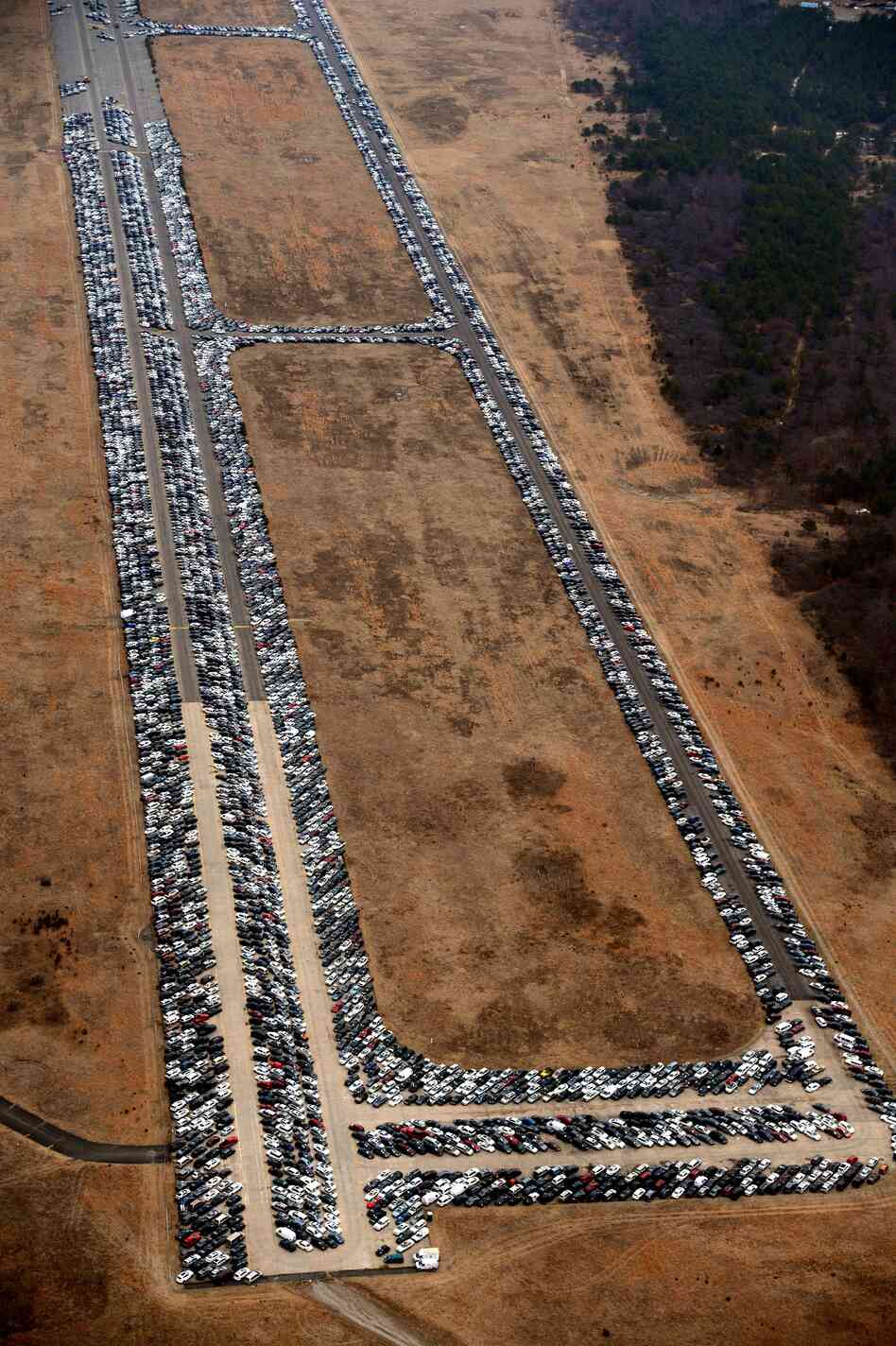 Cars line the runway and taxiways at Calverton Executive Airpark in Calverton, N.Y., on Jan. 9. Cars line the runway and taxiways at Calverton Executive Airpark in Calverton, N.Y., on Jan. 9.