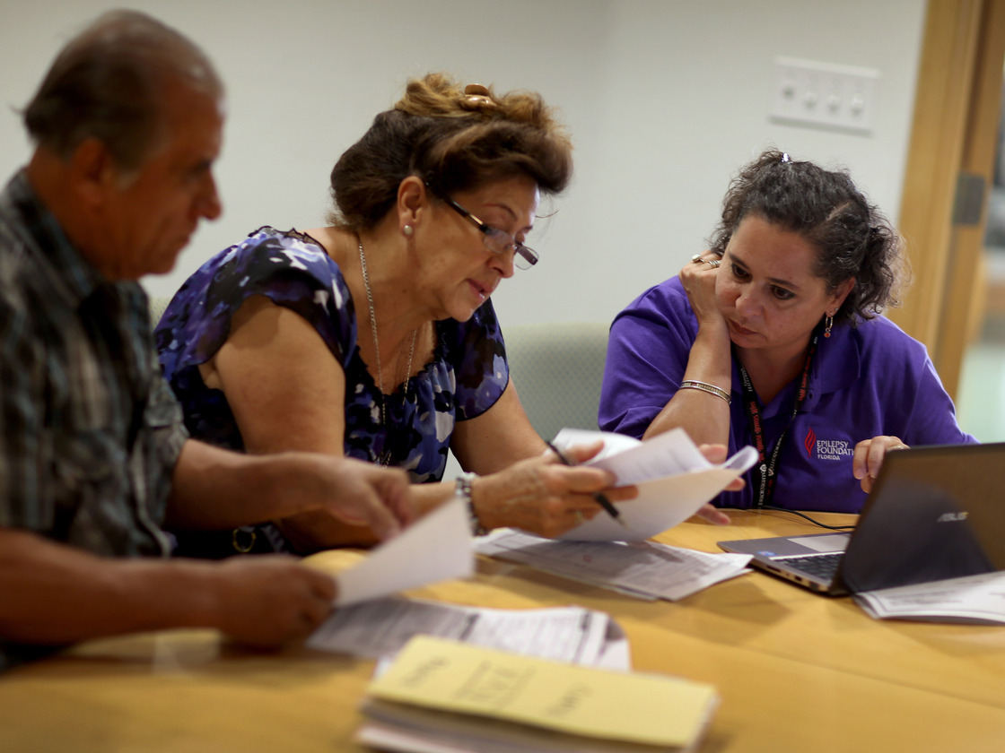 Affordable Care Act navigator Nini Hadwen helps Floridians shop for health insurance in October.