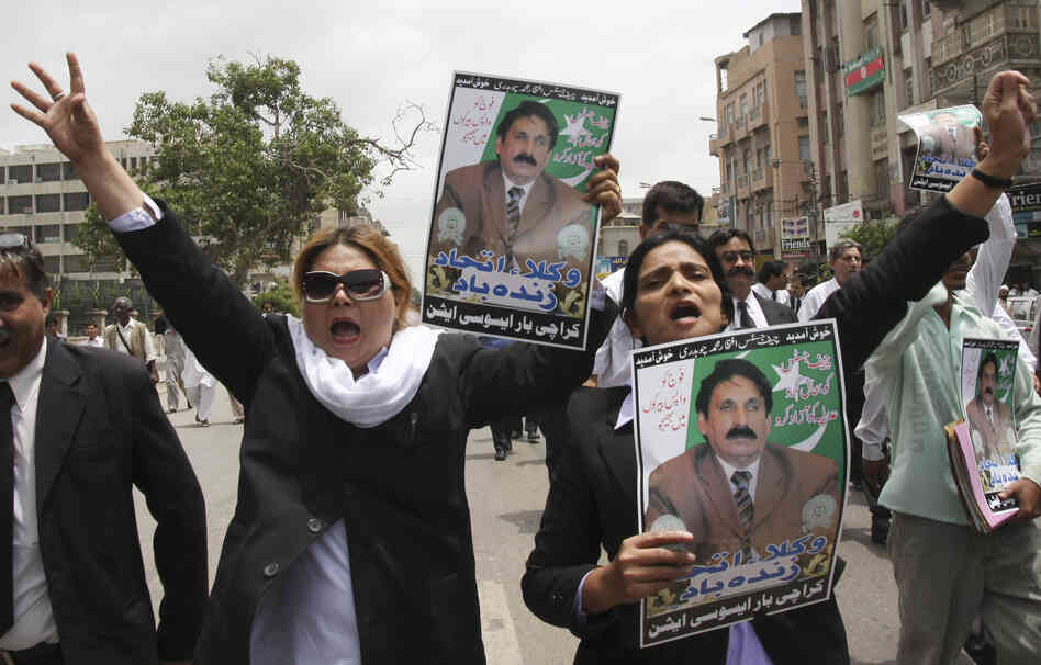 Pakistani lawyers hold portraits of Chaudhry as they chant slogans against then-President Pervez Musharraf during a 2008 rally in Karachi demanding the restoration of all deposed judges. Pakistani lawyers hold portraits of Chaudhry as they chant slogans against then-President Pervez Musharraf during a 2008 rally in Karachi demanding the restoration of all deposed judges.