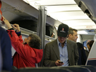A passenger checks his cellphone while boarding a flight in Boston. The Federal Communications Commission is proposing new rules to allow using cellphones for data and voice calls during airline flights. A passenger checks his cellphone while boarding a flight in Boston. The Federal Communications Commission is proposing new rules to allow using cellphones for data and voice calls during airline flights.
