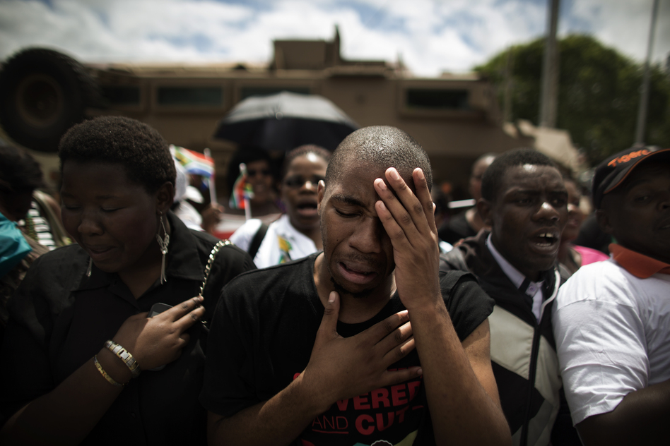 South Africans react after the hearse carrying Mandela's coffin drives by in Mthatha on Saturday. Mandela will embark on the final leg of his exceptional 95-year journey on Saturday, when his remains are returned to his rural childhood home in Qunu for traditional burial.