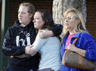 Senior Jenni Meyers, center, is hugged by her sister Mary as they leave a church with their mother Julie after they were reunited after a shooting at nearby Arapahoe High School in Centennial, Colo. Senior Jenni Meyers, center, is hugged by her sister Mary as they leave a church with their mother Julie after they were reunited after a shooting at nearby Arapahoe High School in Centennial, Colo.