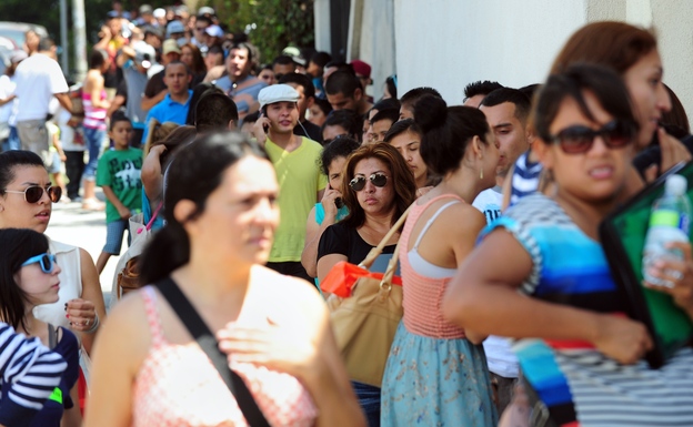 A crowd forms a line around the block from the office of The Coalition for Humane Immigrant Rights of Los Angeles (CHIRLA) on the first day of the Deferred Action for Childhood Arrivals (DACA) program. (Image credit: AFP/Getty Images)