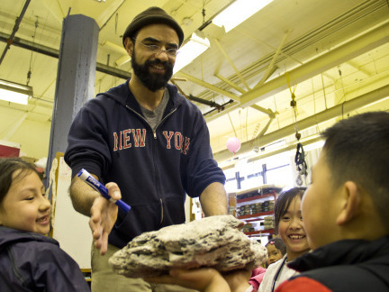 Teacher Aaron Martin and his class examine lava rocks before making their own at the Mission Science Workshop. Teacher Aaron Martin and his class examine lava rocks before making their own at the Mission Science Workshop.