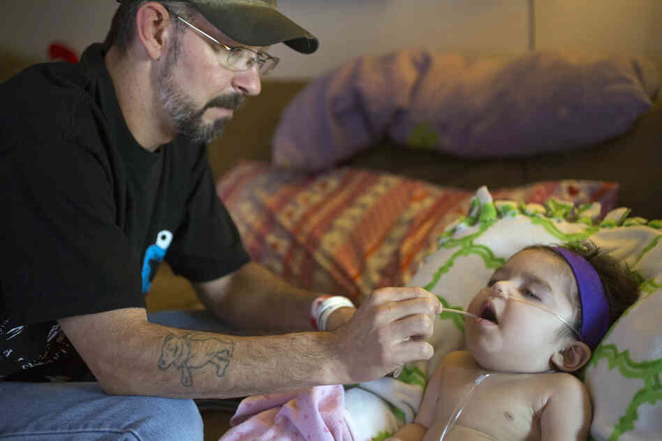Anthony Shaffer uses a suction device to clear the mouth of Jaylah Donaire-Bechtel, in Harrisburg, Pa. Jaylah has Krabbe disease and can't swallow or speak. Anthony Shaffer uses a suction device to clear the mouth of Jaylah Donaire-Bechtel, in Harrisburg, Pa. Jaylah has Krabbe disease and can't swallow or speak.