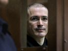 Former Yukos oil company CEO Mikhail Khodorkovsky looks through the defendant's glass cage in a Moscow courtroom on Nov. 1, 2010. Former Yukos oil company CEO Mikhail Khodorkovsky looks through the defendant's glass cage in a Moscow courtroom on Nov. 1, 2010.