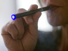 Photo illustration of a woman smoking an e-cigarette Photo illustration of a woman smoking an e-cigarette