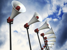 An array of loudspeakers against a dramatic sky. 3D render with HDRI lighting and raytraced textures. An array of loudspeakers against a dramatic sky. 3D render with HDRI lighting and raytraced textures.