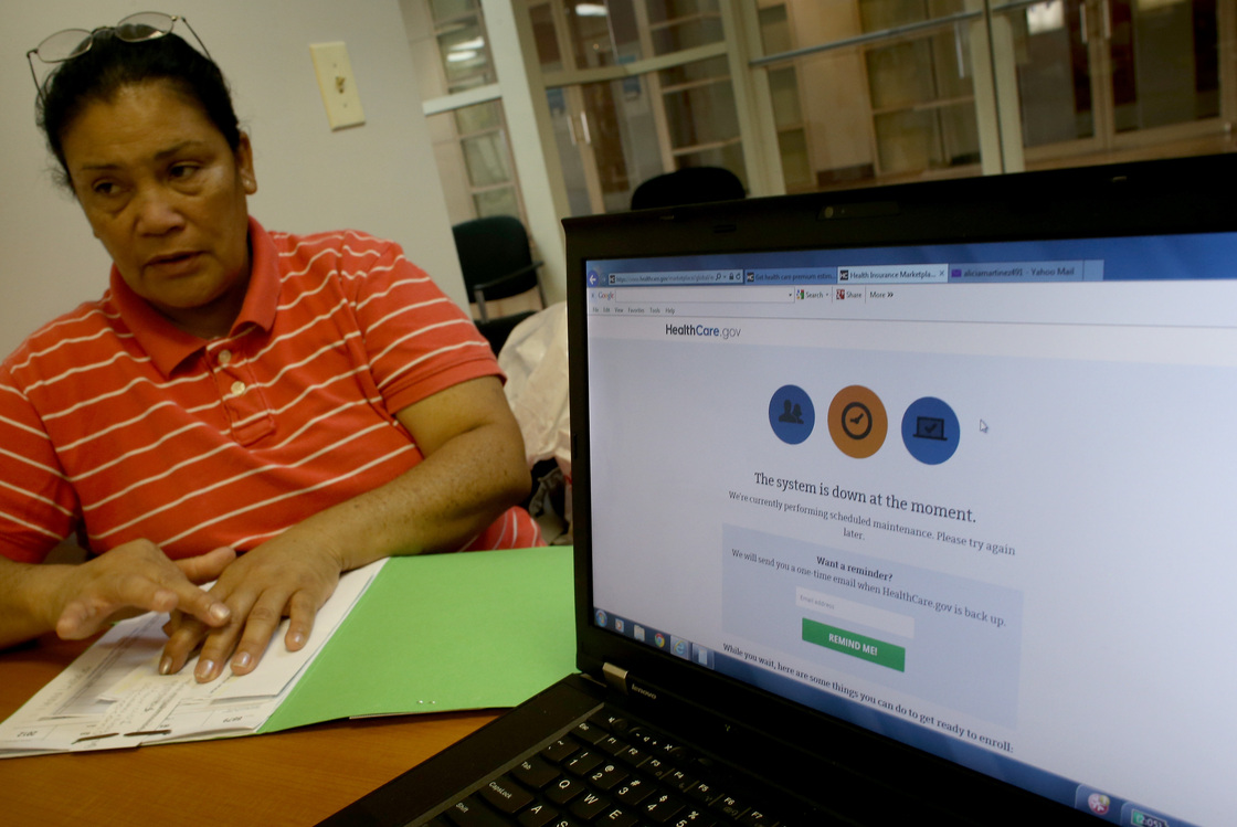 Alicia Martinez tries to sign up for a health care plan at a Miami Enrollment Assistance Center on Dec. 20, in Miami, Fla.