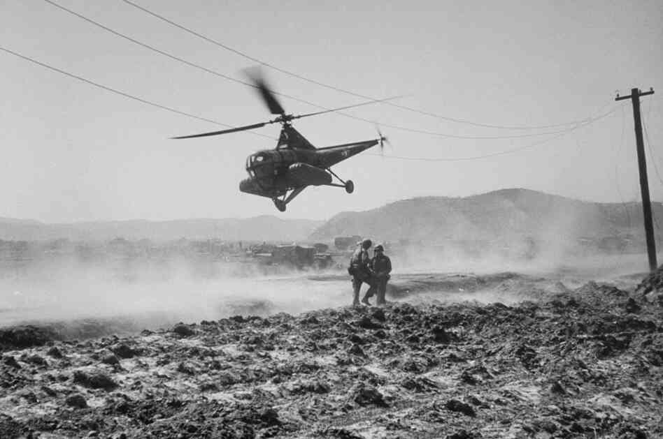 Helicopter ambulance taking off on a flight to Seoul, Korean War, March 1951