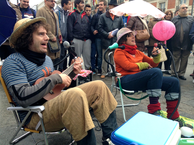 Gerardo Yllera, left, and Laura Nadal play for money in the streets of Madrid. Yllera and Nadal, who form the Potato Omelette Band, are among more than 300 street musicians who were forced last month to audition for the privilege of holding out a hat in the streets of Madrid. A viral video of their audition — complete with lyrics criticizing the new policy — has made them somewhat famous. (Image credit: NPR)