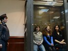 Pussy Riot members Yekaterina Samutsevich (left), Maria Alyokhina and Nadezhda Tolokonnikova sit in a glass-walled cage in a Moscow court on Oct. 10, 2012. Pussy Riot members Yekaterina Samutsevich (left), Maria Alyokhina and Nadezhda Tolokonnikova sit in a glass-walled cage in a Moscow court on Oct. 10, 2012.
