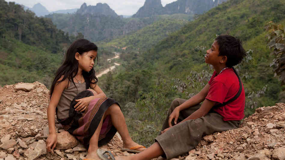 Kia (Loungnam Kaosainam) and Ahlo (Sitthiphon Disamoe) bond when they encounter each other in a Laotian refugee village in The Rocket. Kia (Loungnam Kaosainam) and Ahlo (Sitthiphon Disamoe) bond when they encounter each other in a Laotian refugee village in The Rocket.