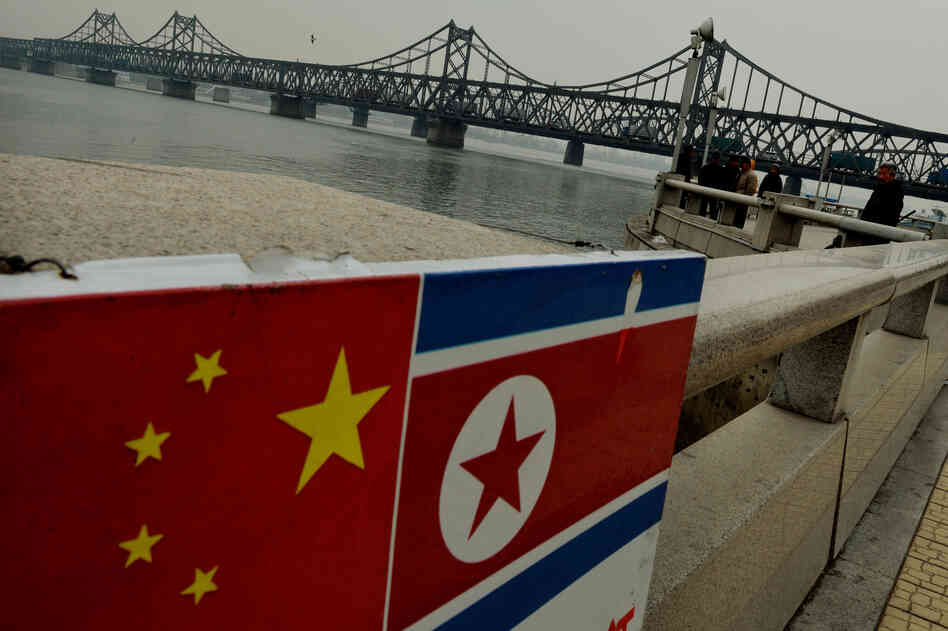 The Chinese and North Korean flags are seen attached to a railing as trucks carrying Chinese-made goods cross into North Korea on the Sino-Korean Friendship Bridge at the Chinese border town of Dandong on Dec. 18, 2013. Ties between the two longtime allies are strained after the execution of the North Korean official in charge of economic relations with China. The Chinese and North Korean flags are seen attached to a railing as trucks carrying Chinese-made goods cross into North Korea on the Sino-Korean Friendship Bridge at the Chinese border town of Dandong on Dec. 18, 2013. Ties between the two longtime allies are strained after the execution of the North Korean official in charge of economic relations with China.