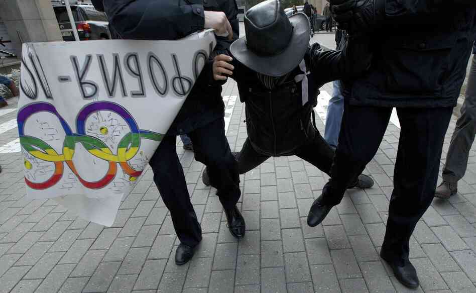 Russian police officers detain a gay-rights activist during a protest outside the Winter Olympics organizing committee office in Moscow. Clashes over gay rights put NBC in a difficult position: Olympic officials insist that the games should not be politicized, while activists push the network to report on the issue as a journalistic enterprise. Russian police officers detain a gay-rights activist during a protest outside the Winter Olympics organizing committee office in Moscow. Clashes over gay rights put NBC in a difficult position: Olympic officials insist that the games should not be politicized, while activists push the network to report on the issue as a journalistic enterprise.