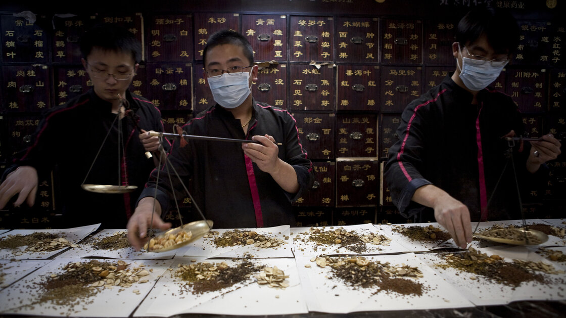Workers prepare Chinese traditional medicine for customers in Beijing. Workers prepare Chinese traditional medicine for customers in Beijing.