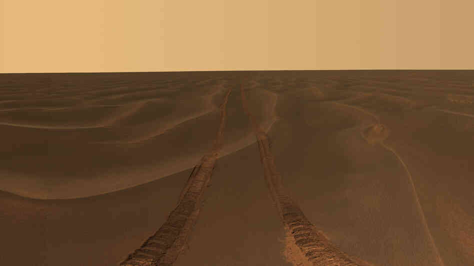 Tracks from NASA's Opportunity rover disappear toward the horizon on the Meridiani Plains of Mars. The rover has been on the planet since 2004. Tracks from NASA's Opportunity rover disappear toward the horizon on the Meridiani Plains of Mars. The rover has been on the planet since 2004.