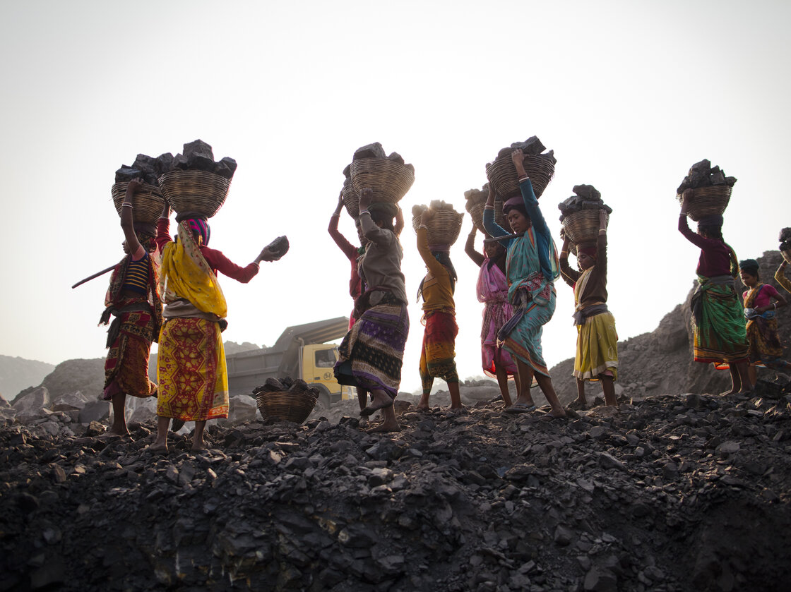 Local villagers scavenging coal illegally from an open-cast mine in a village near Jharia, India, in 2012. Local villagers scavenging coal illegally from an open-cast mine in a village near Jharia, India, in 2012.