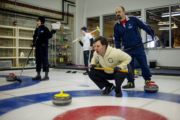 Potomac Curling Club members (from left) Miriam Terninko, Christopher Richard, Joe Rockenbach and Henrique Kempenich await the arrival of stones to the house during a match Jan. 18 at National Capital Curling Center in Laurel, Md. (Image credit: NPR)