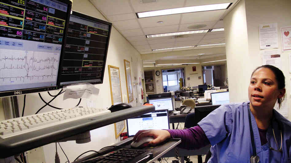 Amanda Gerety, a staff nurse at Boston Medical Center, checks monitors that track patients' vital signs. Fewer beeps means crisis warnings are easier to hear, she says. Amanda Gerety, a staff nurse at Boston Medical Center, checks monitors that track patients' vital signs. Fewer beeps means crisis warnings are easier to hear, she says.