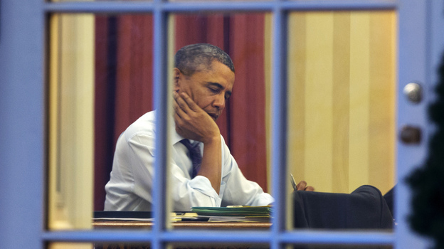 President Obama, working at his desk Monday night on the eve of his 2014 State of the Union address. (AP)
