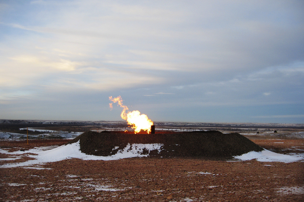 Gas flaring near Highway 85 southwest of Williston. Analysts estimate that almost 30 percent of the gas being produced in the state is burned off. (Image credit: Jeff Brady/NPR)